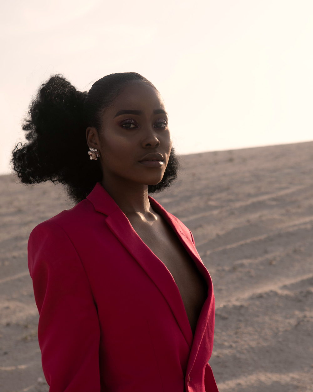 A woman with her hair in a high puff, outdoors